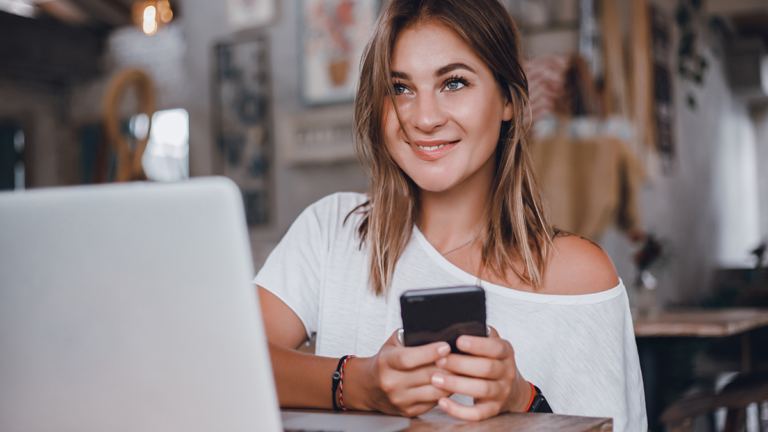 Woman sending email on mobile phon e